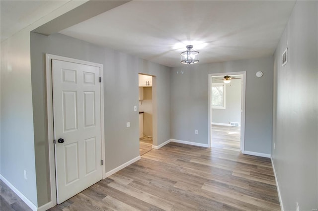 unfurnished room featuring light hardwood / wood-style floors and ceiling fan