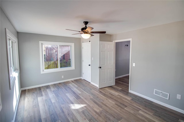 unfurnished room with hardwood / wood-style flooring and ceiling fan