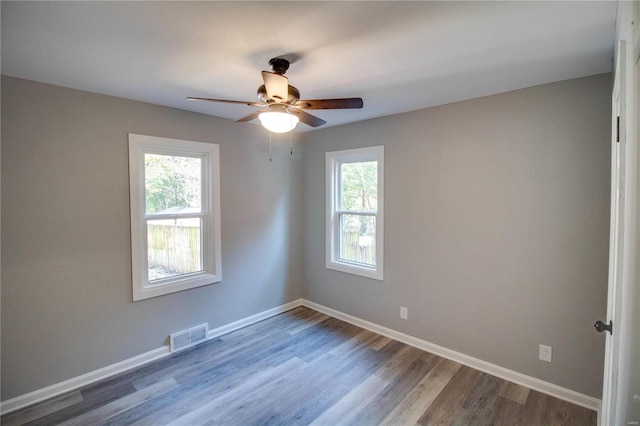 empty room with hardwood / wood-style flooring and ceiling fan