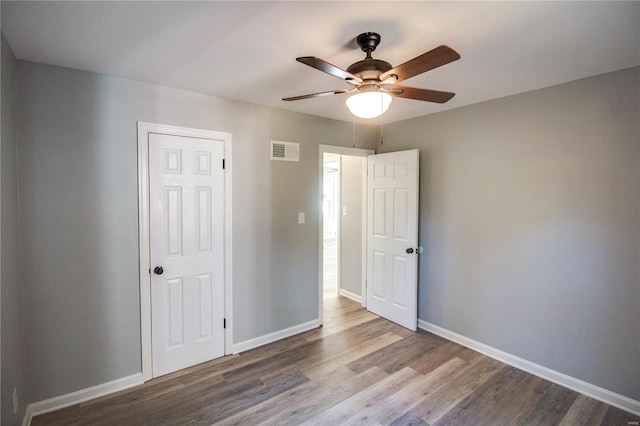 unfurnished bedroom featuring wood-type flooring and ceiling fan