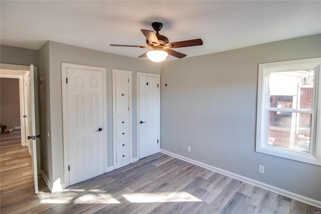 unfurnished bedroom featuring light wood-type flooring and ceiling fan