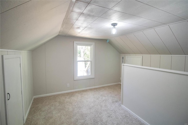 bonus room featuring light carpet and vaulted ceiling