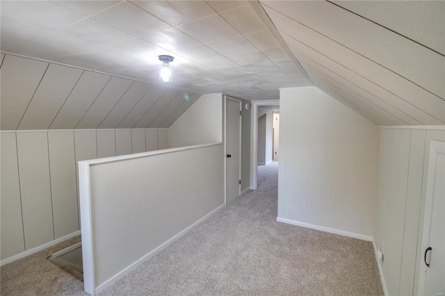 additional living space featuring light carpet and lofted ceiling