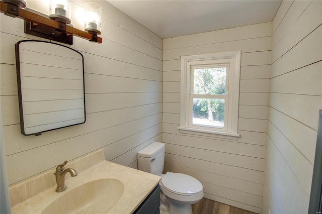 bathroom featuring wooden walls and hardwood / wood-style flooring