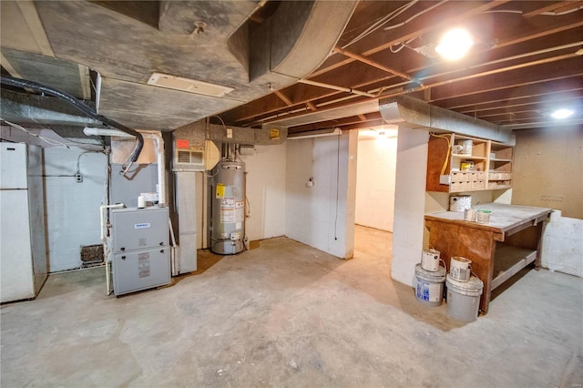 basement with heating unit, gas water heater, and white refrigerator