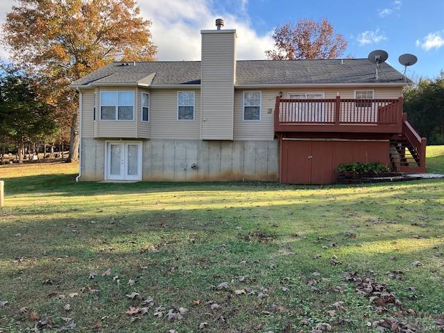 back of house featuring a yard and a wooden deck