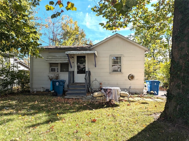 back of property featuring a lawn