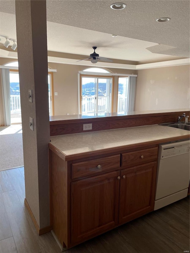 kitchen featuring dishwasher, plenty of natural light, sink, and a textured ceiling