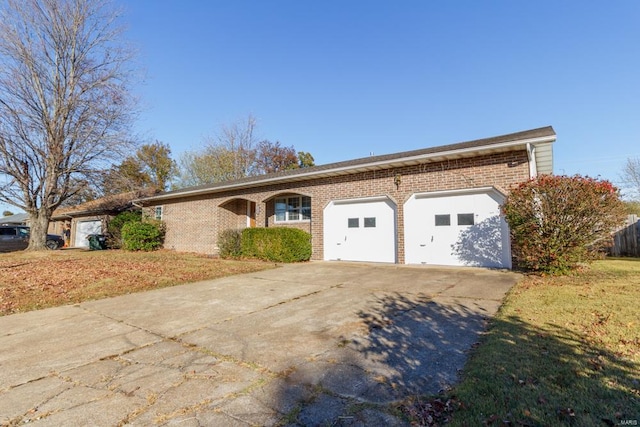 ranch-style house with a garage and a front yard