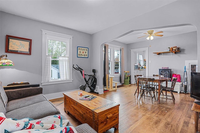 living room with light wood-type flooring and ceiling fan