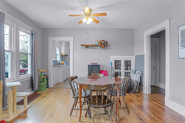 dining space featuring light hardwood / wood-style floors and ceiling fan