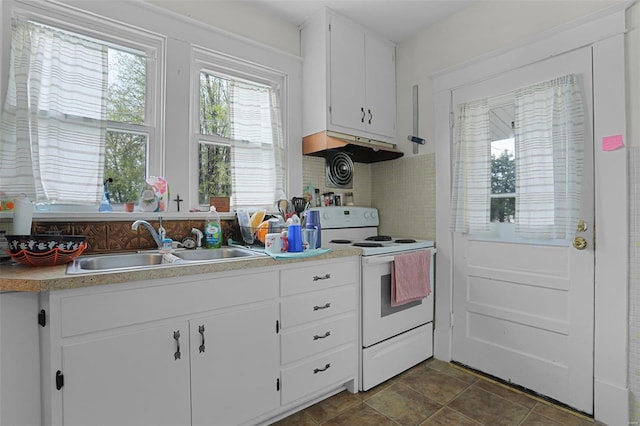 kitchen with white cabinetry, a wealth of natural light, sink, and electric range