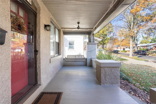 view of patio with ceiling fan and a porch