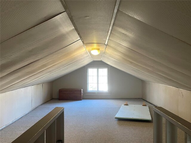 bonus room featuring light carpet and lofted ceiling