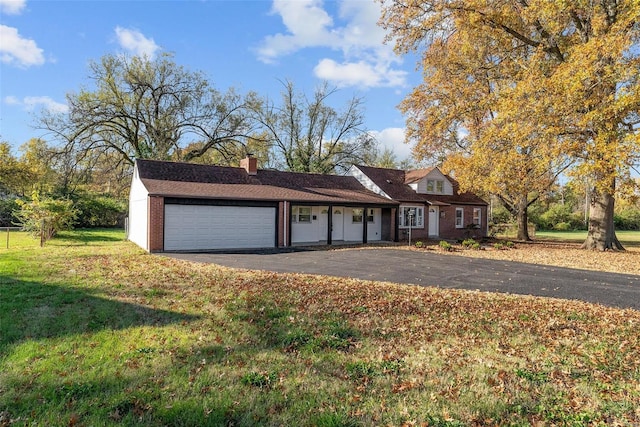 view of front of property with a garage and a front lawn