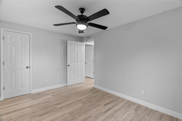 unfurnished bedroom with ceiling fan and light hardwood / wood-style floors