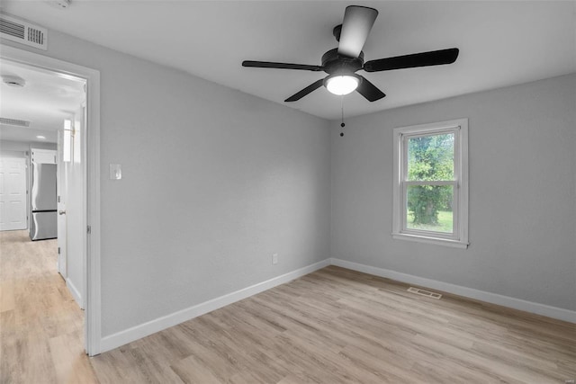 spare room featuring ceiling fan and light wood-type flooring