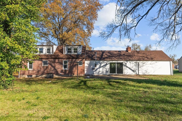 back of property with central air condition unit and a lawn