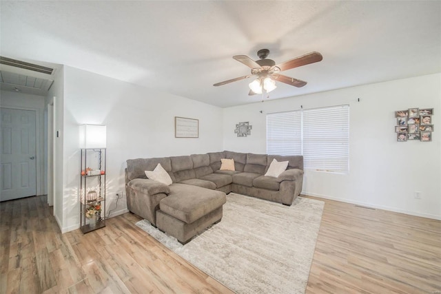 living room featuring light hardwood / wood-style floors and ceiling fan