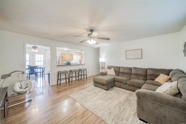 living room with hardwood / wood-style flooring and ceiling fan