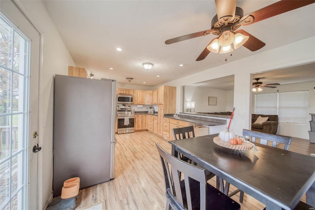 dining area featuring ceiling fan and light hardwood / wood-style flooring