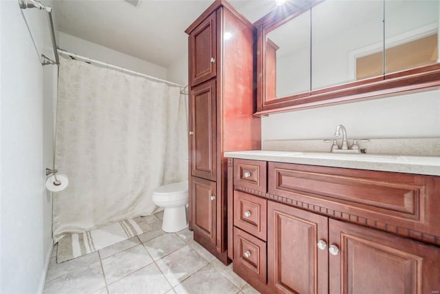 bathroom featuring tile patterned flooring, vanity, and toilet