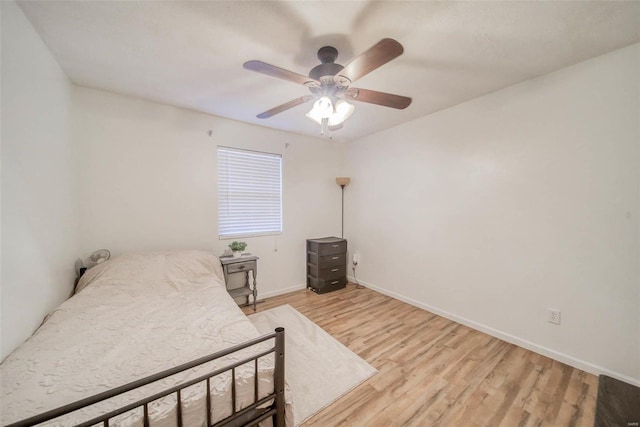 bedroom with ceiling fan and light hardwood / wood-style flooring