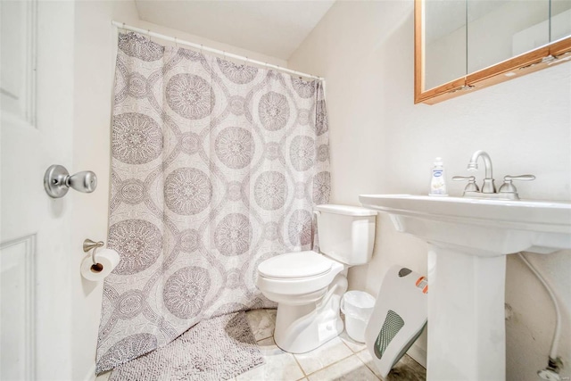 bathroom featuring tile patterned flooring and toilet