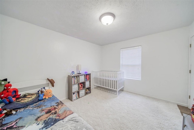 carpeted bedroom with a textured ceiling