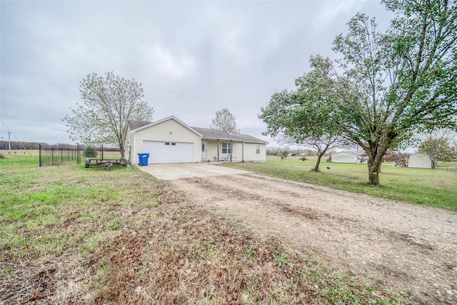 ranch-style house featuring a front yard and a garage