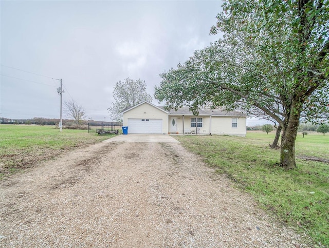 ranch-style house with a garage, a rural view, and a front lawn