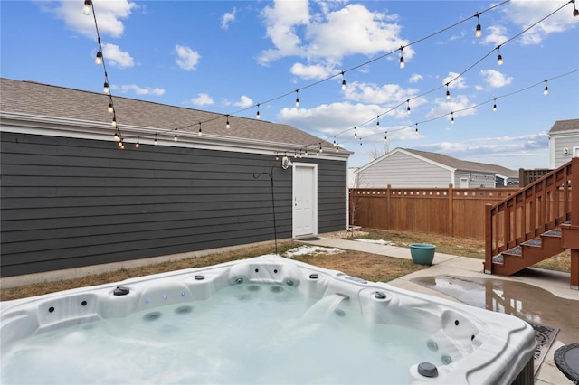 view of patio / terrace with fence and a hot tub