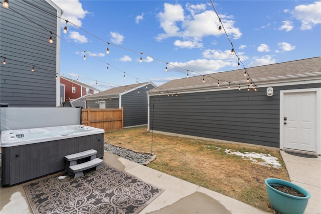 view of yard featuring a hot tub, central AC, and fence