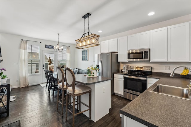 kitchen featuring a sink, dark countertops, and stainless steel appliances