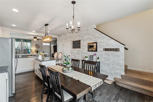 dining space featuring dark wood-style flooring, recessed lighting, stairway, baseboards, and an accent wall