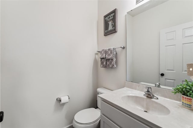 half bathroom featuring toilet and vanity