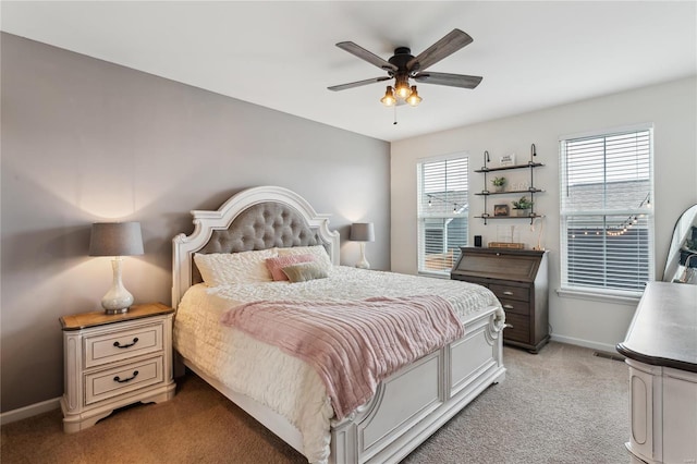 bedroom featuring light carpet, visible vents, ceiling fan, and baseboards