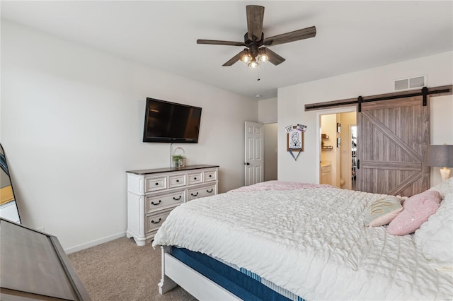 bedroom with a ceiling fan, carpet, visible vents, baseboards, and a barn door