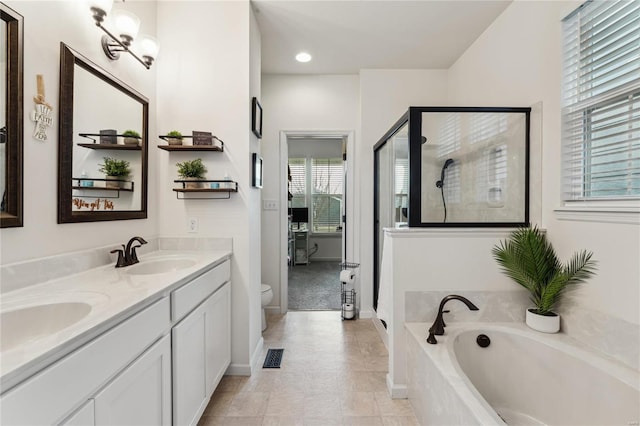 bathroom featuring a sink, visible vents, a garden tub, and a stall shower