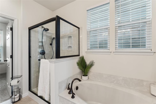 bathroom with a garden tub and a shower stall