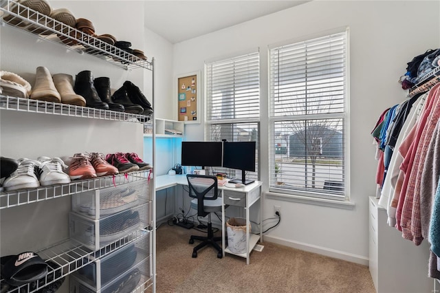 carpeted office featuring baseboards