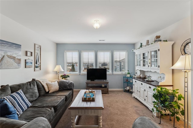 living room featuring baseboards and light carpet