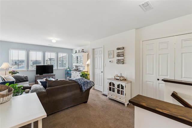 living room featuring visible vents and carpet floors