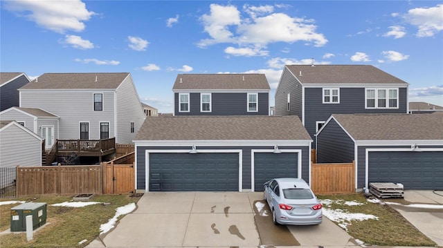 view of front of property featuring a garage, a shingled roof, concrete driveway, and fence