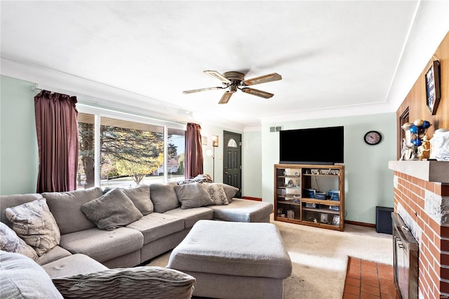 living room with a brick fireplace, ceiling fan, and light carpet