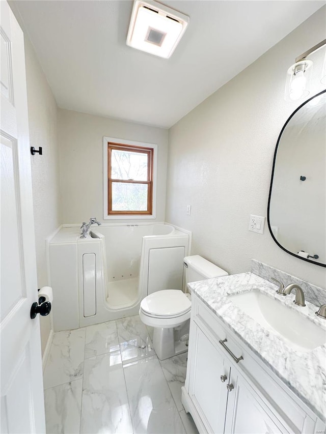 bathroom featuring a tub, vanity, and toilet