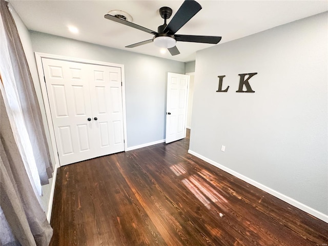 unfurnished bedroom with a closet, ceiling fan, and dark hardwood / wood-style floors