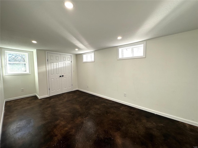 basement featuring a wealth of natural light and a textured ceiling