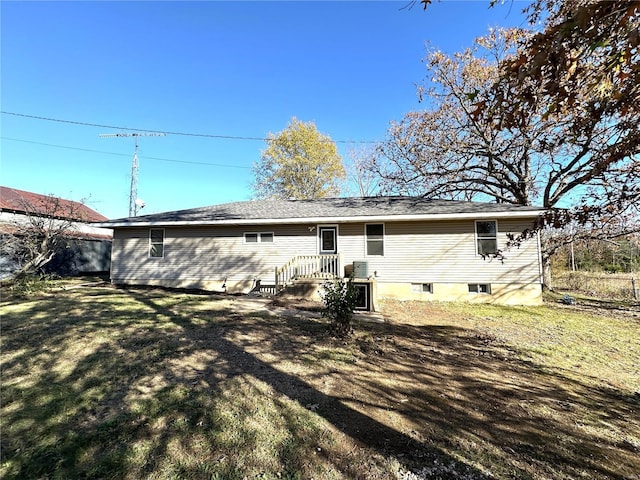 rear view of property with a yard