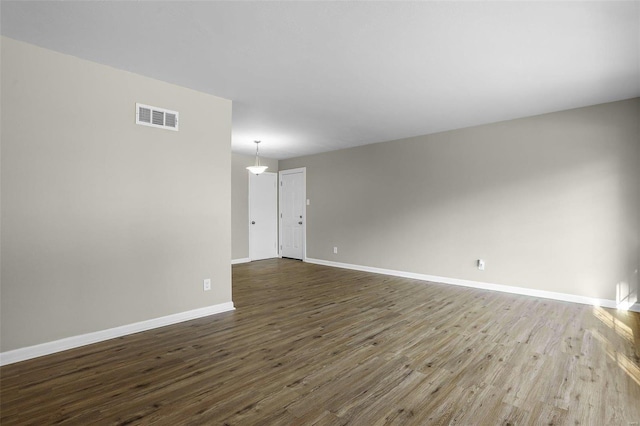 unfurnished room featuring dark hardwood / wood-style floors